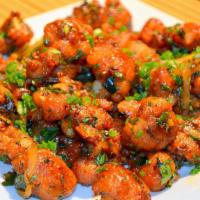 Gobi Manchurian · Cauliflower Wings saute in Sweet Chili Sauce with onions, bell pepper.