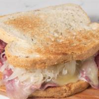 Reuben Sandwich · First cut corned beef with swiss cheese melted on top, sauerkraut, and  thousand island dres...