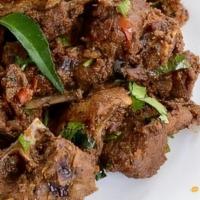 Karvepaku Mutton Fry · Mutton pieces cooked and tossed with south indian curry leaf powder and curry leafs.