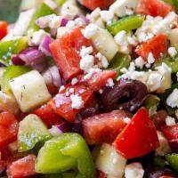 Greek Salad · A mix of lettuce tomatoes and onions topped with feta cheese, oregano, olives, and Greek dre...