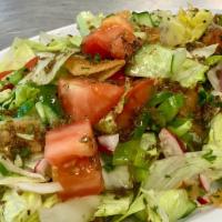 Mediterranean Fattoush Salad · Chopped lettuce, tomatoes, cucumbers, radishes, onions, parsley with toasted pita bread, lem...