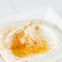 Hummus Dip · Garbanzo bean blended with fresh garlic, lemon juice and tahini drizzled with extra virgin o...