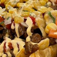 *Super Nachos · Your choice of protein served over crispy tortilla chips, topped with daiya vegan nacho chee...