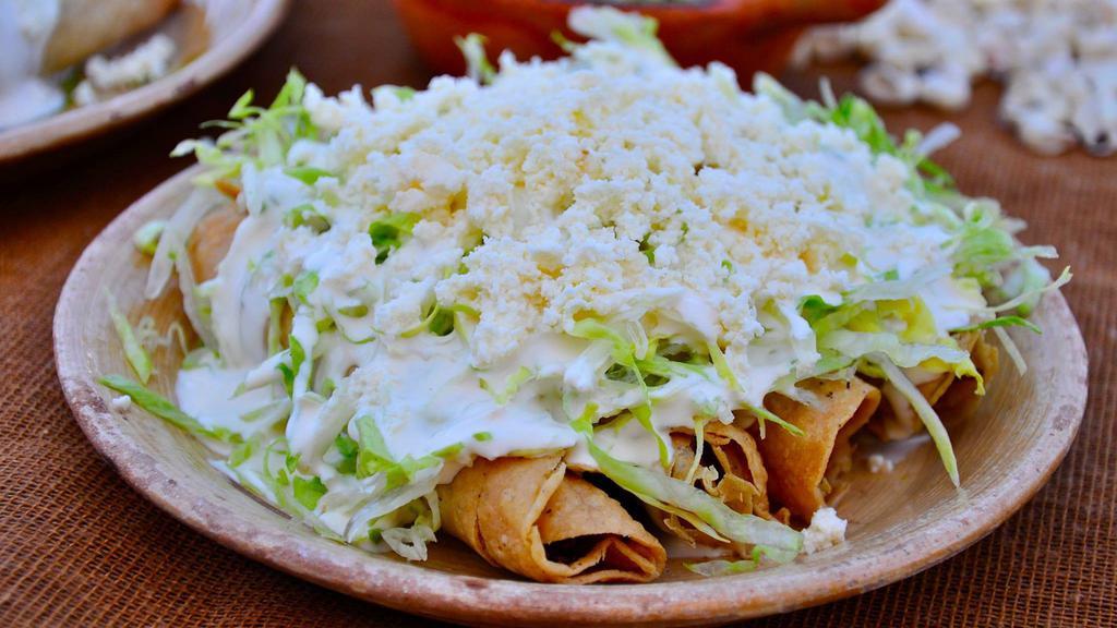 Flautas · Served with rice and beans
