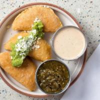 *Empanadas · A trio of fried house masa filled with melted Oaxaca cheese and garnished with cotija and gu...