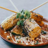 *Mexican Street Corn · Corn on the cobb glazed in chile aioli, cotija cheese, and cilantro. Served lollipop style!