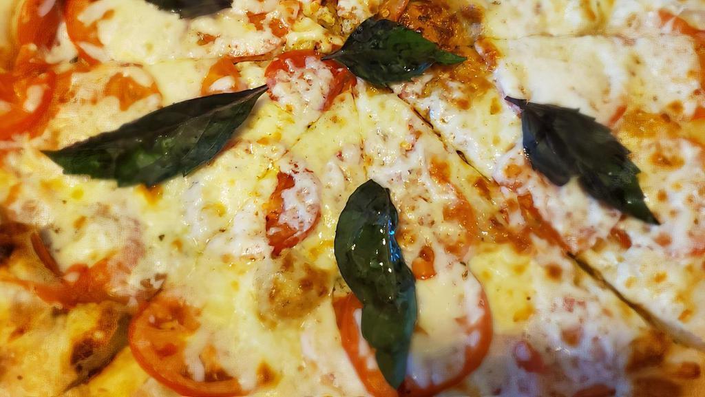 Margarita Pizza · Roma tomatoes, garlic, fresh basil, mozzarella cheese, and pizza sauce.