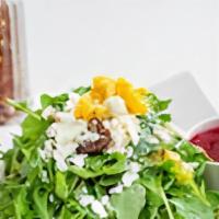 Arugula Salad · Feta cheese, dates, cherry tomatoes, and corn with lemon dressing.