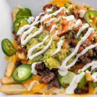 Asada Fries · French fries topped with cheese, asada, guacamole, and sour cream.