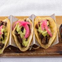 Short Rib Tacos · 3 braised short rib tacos, topped with pickled onion, salsa and cilantro.