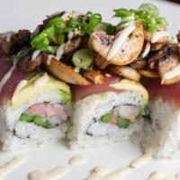 One Man Can Change The World · Diced hamachi, green onions, and asparagus topped with avocado and maguro. Covered with saut...