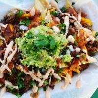 Ground Beef Nachos · Home made Corn tortillas chips, ground beef, cilantro, onions, guacamole, spicy salsa, thous...