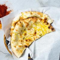 Cheese Naan · Freshly baked bread in a clay oven garnished with cheese