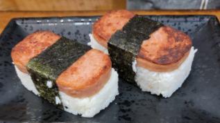 Spam Musubi · 2 pcs of grilled spam, rice, sesame seeds, nori.