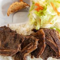 Korean Short Ribs Combo · Korean beef short ribs over a bed of rice. Comes with a fried pork potsticker, side salad wi...