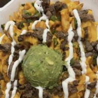 Loaded Fries · Seasoned waffle fries, choice of meat, nacho cheese, sour cream, green onions and guac.