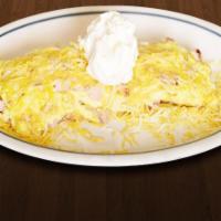 Western Omelette · Ham, hash browns, onions, cheddar cheese and topped with sour cream.