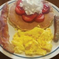 Kids Egg Combo  · One egg, one bacon strip, one sausage link and one regular pancake with choice of banana, bl...