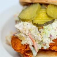 Nashville Hot Chicken Sandwich · Chicken strips dipped in Nashville hot sauce with pickles and ranch on toasted brioche bun.