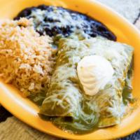 Enchiladas Suizas · Two chicken enchiladas covered with green sauce made from spinach and tomatillos, then toppe...