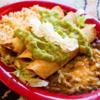 Flautas · Three crispy corn tortillas stuffed with shredded chicken then topped with guacamole and sou...