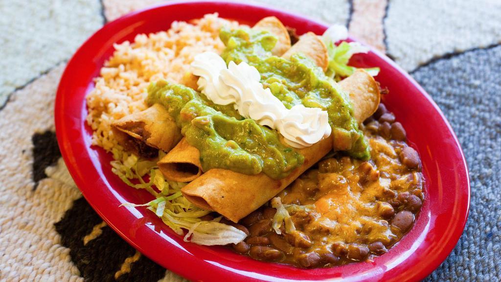 Flautas · Three crispy corn tortillas stuffed with shredded chicken then topped with guacamole and sour cream. Served with rice and our whole pinto beans.