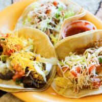 Classic Tacos (A La Carte) · These are our individual tacos topped with lettuce, cheese and salsa cruda. Served a la cart...
