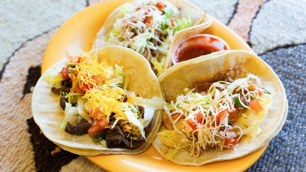 Classic Tacos (A La Carte) · These are our individual tacos topped with lettuce, cheese and salsa cruda. Served a la carte. See Platos Combinaciones for plates with rice and beans.
