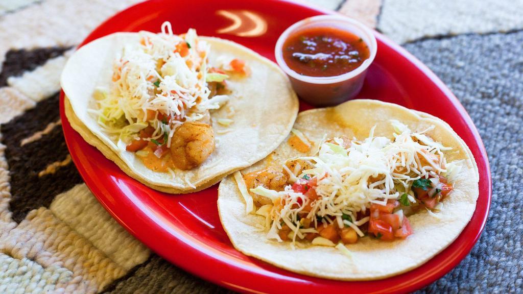 Baja Shrimp Tacos (2 Tacos) · Two soft corn tortilla tacos made with sautéed and seasoned shrimp, shredded cabbage, salsa cruda (pico de gallo), and our chipotle cream sauce.
