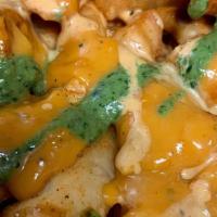 Masala Queso Fries · Masala potato fries smothered in. queso, cilantro and tamarind sauce