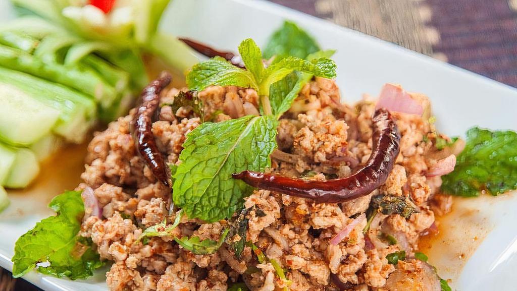Larb Gai · Ground chicken, two hours slow roasted rice powder, red onion, mint, cilantro and in lime dressing.