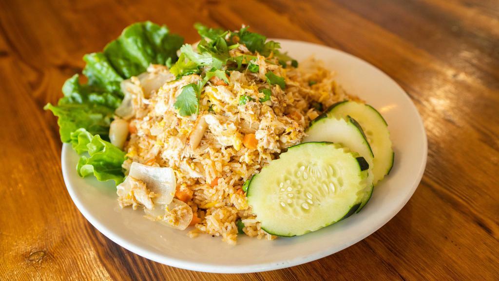 Garlic Crab Fried Rice · Gluten free. White crab meat lightly stir fried with egg, roasted garlic served with and fresh cilantro leaves on top.