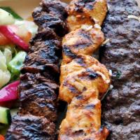 1F Kebab Combo · Beef kofta (spiced ground beef skewers) and your choice of kebab. Served with rice, salad, h...