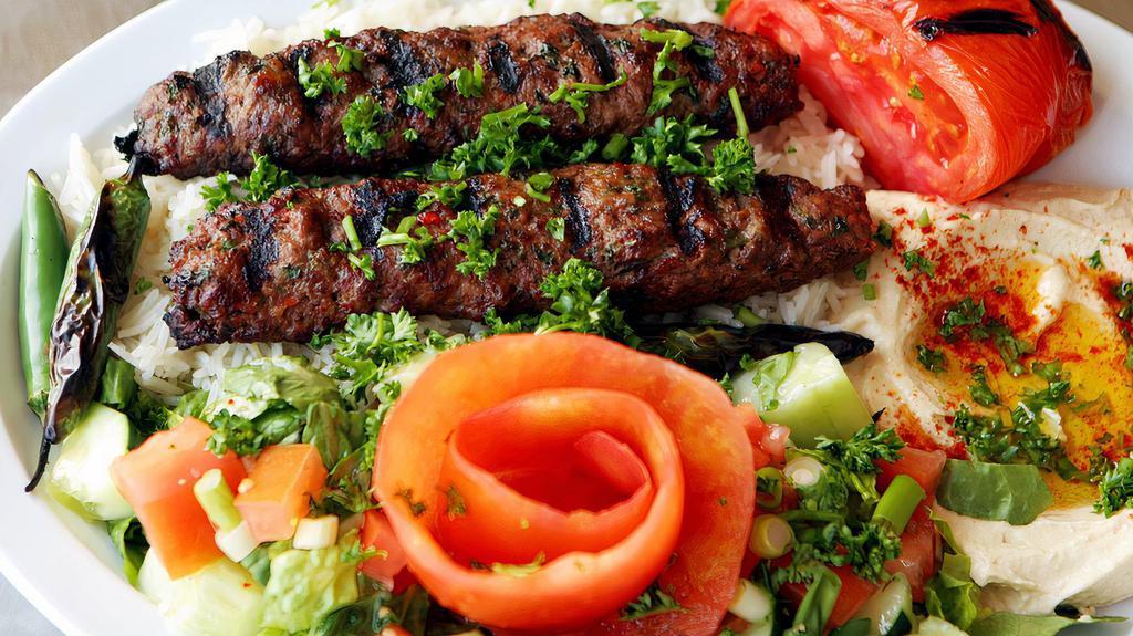 Beef Kofta Plate · Skewered of tender marinated ground beef, grilled to perfection. Served with rice, salad, hummus and pita.