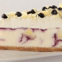 Blueberry Cobbler White Chocolate Cheesecake · Creamy white chocolate cheesecake, moist chunks of vanilla bean cream cake and sweet swirls ...
