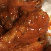 Buffalo Wings (8 Pcs.) · Unbreaded chicken wing, deep-fried then coated or dipped in a sauce.