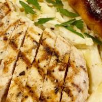 Chicken Alfredo Pasta · Grilled chicken on top of creamy Alfredo sauce and penne pasta served with a house made brea...