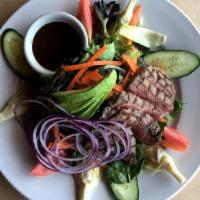 Mediterranean Steak Salad · farm fresh greens, Maui onions, olives, cucumbers, feta cheese, tomatoes and balsamic vinaig...