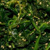 Asian Pearl Spinach Salad · A fresh spinach salad tossed with white sesame seeds, in our  All Savory secret oil and blac...