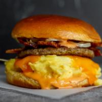 Brioche, Bacon, Sausage, Egg, & Cheddar Sandwich · 2 scrambled eggs, melted Cheddar cheese, smoked bacon, breakfast sausage, and Sriracha aioli...