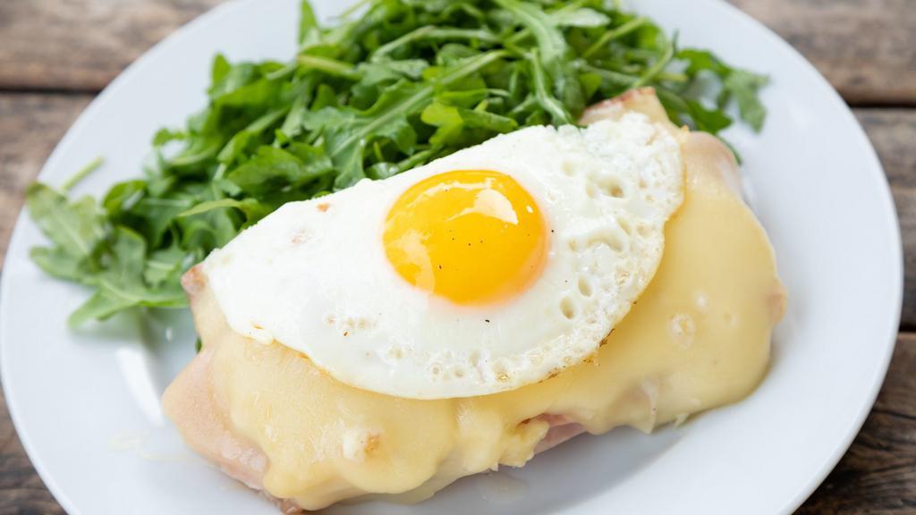 Croque Madame · Grilled French Ham, Gruyere & Dijon Mustard on Pain de Mie, Topped with Béchamel & Sunny Side-Up Egg with Arugula Salad