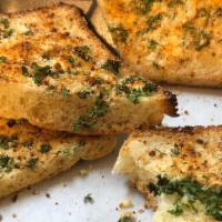 Garlic Bread · Our homemade bread toasted with garlic, oil, Parmesan and parsley.