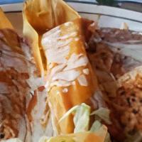 Tamales · 2 Fresh corn masa wrapped in corn husk, filled with choice of Pork, Chicken or Beef covered ...