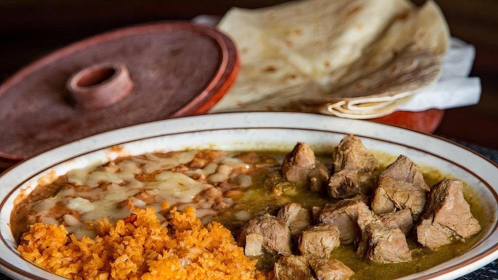 Chile Verde · Tender lean pork simmered in green tomatillo sauce.  Served with rice & beans