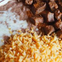 Chile Colorado · Tender cubed beef simmered in red chile sauce.  Served with rice & beans