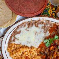 Steak Ranchero · Strip steak simmered in peppers, onions, cilantro, tomatoes and fresh spices.  Served with r...