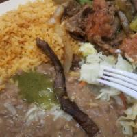 Steak Ranchero · Ranch style steak sauteed with onion, bell pepper & tomatoes with side of beans, rice & tort...