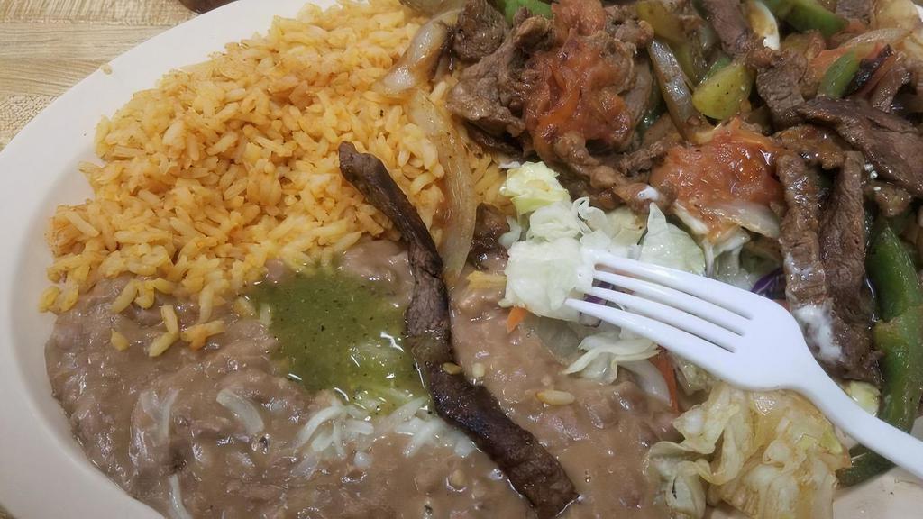 Steak Ranchero · Ranch style steak sauteed with onion, bell pepper & tomatoes with side of beans, rice & tortillas.
