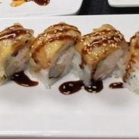 Monkey Roll · Tempura shrimp, cream cheese, crab, and avocado topped with fried banana, and eel sauce.