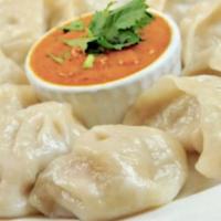 Chicken Momo (Nepalese Style Dumpling - 8 Pieces) · Most popular dishes in Nepal made with minced chicken, in combination with onion, cilantro, ...